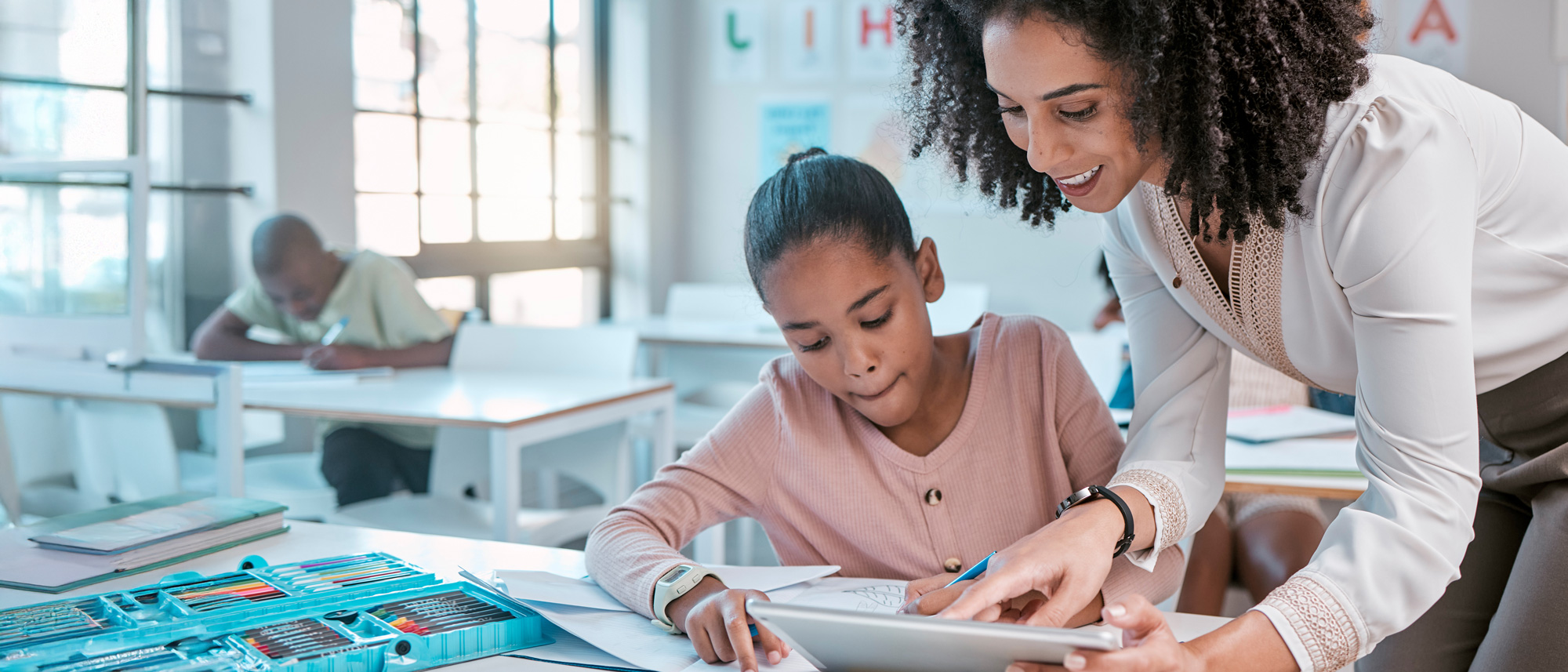 Teacher helping a student with her work