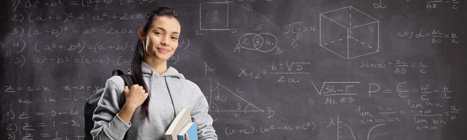 Femail student in front of blackboard full of math equations