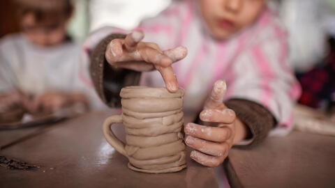 child with clay