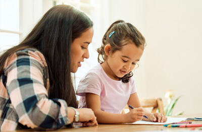 Teacher sitting down with a young student